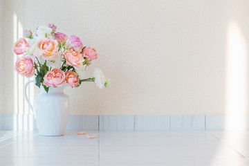 beautiful roses in ceramic white jug