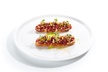 Beef Tartare on Toast with Black Garlic Cream Isolated