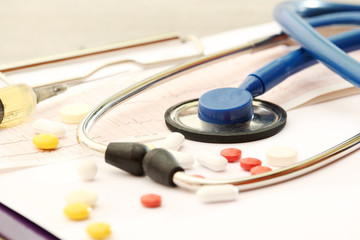 A stethoscope and different medicine pills as a medicine concept	