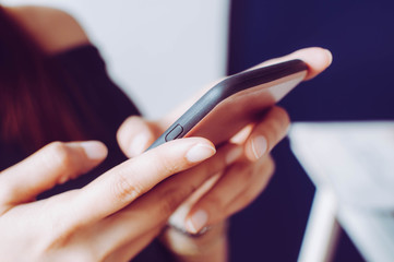 A young woman is using a mobile phone