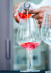 pink gin tonic in preparation with ice 