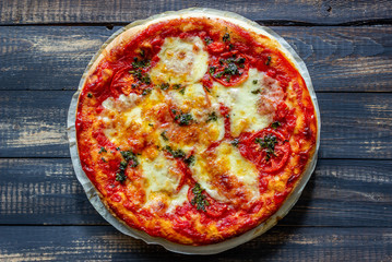Italian pizza with tomatoes and mozzarella cheese. Italian cuisine. Margherita.