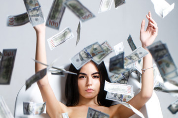 Woman with lot of money. Millionaire woman lying in bedroom. Sexy woman lying in dollar bills. Rich sexy woman lies on money. Currency, women, winning. Sexy female and dollar bills