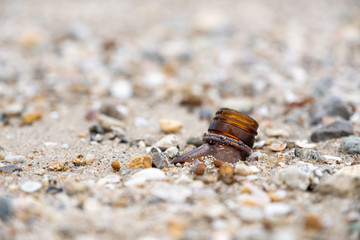 Closeup image of broken glass bottles on the beach