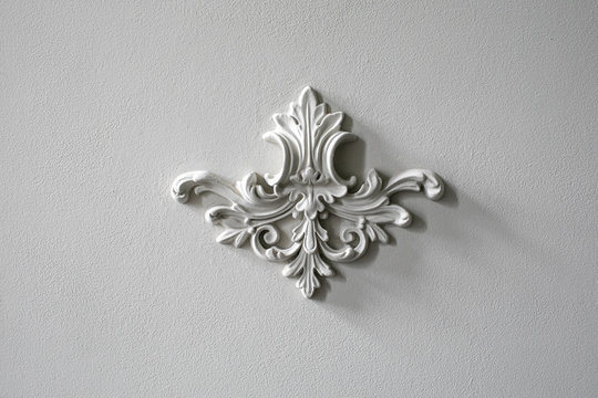 White wall molding with geometric shape and vanishing point. Luxury white wall design bas-relief with stucco mouldings roccoco element