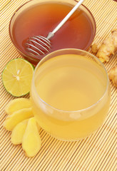 Hot ginger tea with lime and honey on bamboo mat