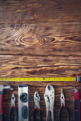 Close up tools on a wooden background.