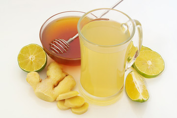 Ginger tea cup, lime and honey on table