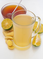 Ginger tea cup, lime and honey on table