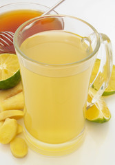 Ginger tea cup, lime and honey on table close up