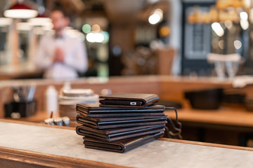 Electronic menu or bill in the restaurant in the form of a smartphone tablet, with built-in advertising. Successful people, businessman in comfortable cafe .