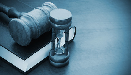 Judge gavel, hourglass and legal book, court time concept