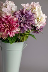 Silk flowers in a tall metal vase