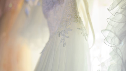 White wedding dress with lace, seen from close up, in natural light