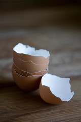 Stacked eggshells on a wooden tabletop