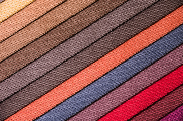 Colorful and bright fabric samples of furniture and clothing upholstery. Close-up of a palette of...