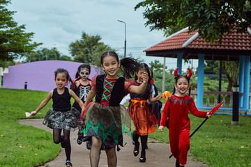 Asian girl kids trick or treat on street