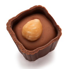 Small chocolate basket with cream and nut on a white background