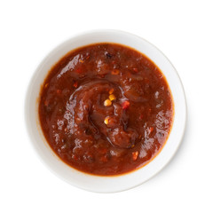 Salsa sauce in a white bowl, isolated on white background. Top view