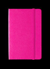 Magenta pink closed notebook isolated on black