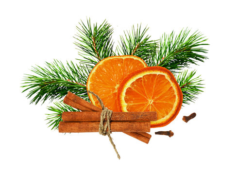 Dry orange, cinnamone, cloves and green pine twigs in a Christmas arrangement