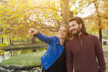 Couple in the park enjoying nice autumn time.