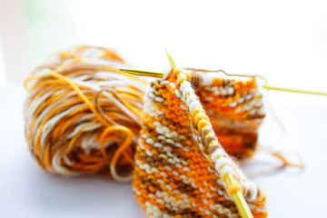 Knitting wool or woven yarn with metal stick as leisure of woman handicraft. Handmade scarf of wool tread as knitwear for warm cloth