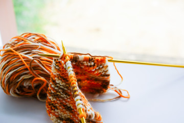 Knitting wool or woven yarn with metal stick as leisure of woman handicraft. Handmade scarf of wool tread as knitwear for warm cloth