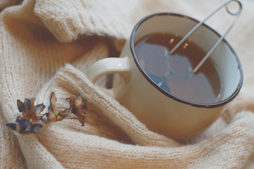 cup of ten and knitted beige sweater