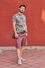 Young man posing in front of a camera.