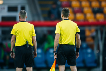 Two football referee watch the game