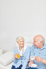 Happy seniors couple is drinking a cup of coffee