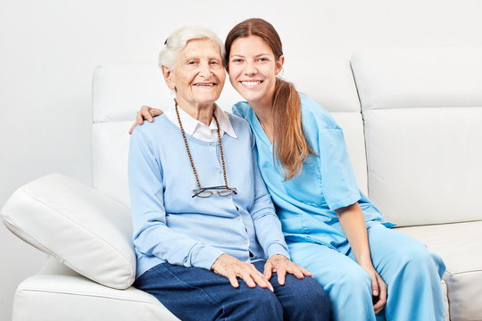 Smiling nursing assistant and happy senior citizen