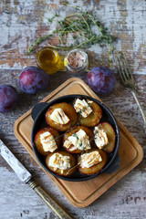 Keto snack. Baked plums with feta cheese and thyme. Keto friendly. Selective focus. Macro.