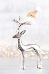 Christmas reindeer on bokeh silver background. Christmas or New Year minimal concept.