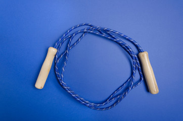 Skipping rope on the dark blue background.Empty space for design