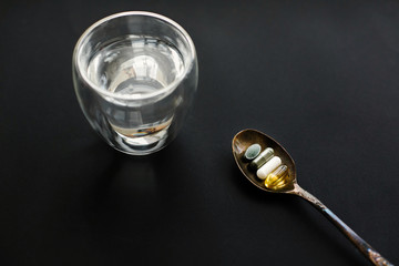 Dietary supplements. Dose of daily vitamins. Omega 3, spirulina, chlorophyll, magnesium capsules on...
