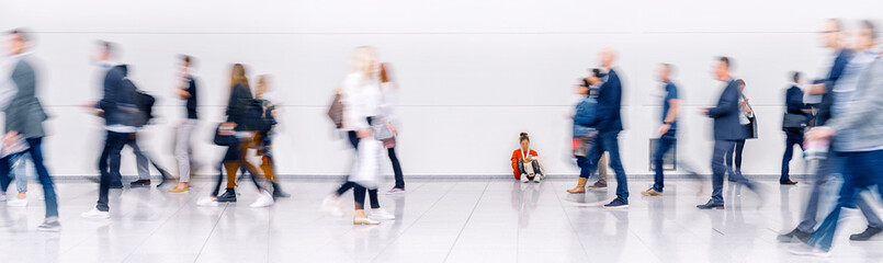 Beautiful motion blur of walking people. Early morning rush hours, busy modern life concept. Ideal for websites and magazines layouts