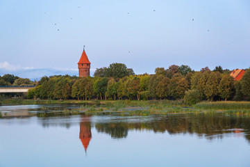 Obraz premium Malbork castle over the Nogat river at sunset, Poland
