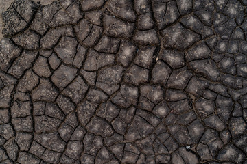 Black cracked surface. Old bitumen texture. Black background