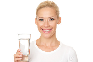 Beautiful smiling model is holding a glass of water.