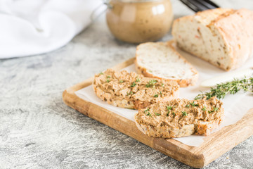 Fresh homemade chicken liver pate. Chicken liver pate on bread and in jar on a light background