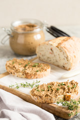 Fresh homemade chicken liver pate. Chicken liver pate on bread and in jar on a light background