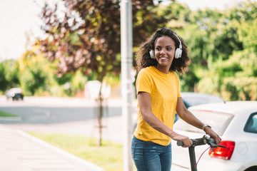 Girl driving electronic scooter in park