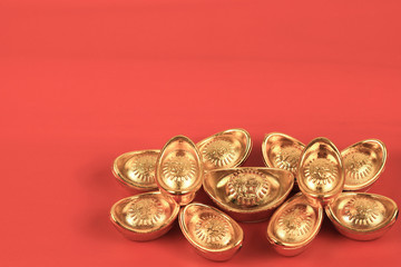 Golden chinese traditional money on red color background. Representing rich, wellness, properity, lucky, happiness for Chinese New Year celebration