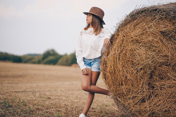 Naklejka na ściany i meble Teen girl hay. Dream. Meadow. Little girl. Nature. Portrait. 