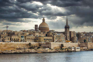 Fototapeta na wymiar Valletta city skyline with a moody dramatic sky in the background