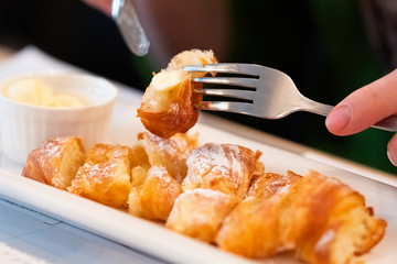 Croissant with butter for breakfast