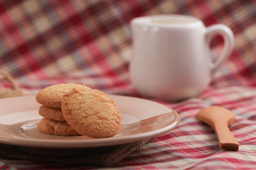 Round sweet cookies. Delicious dessert with high sugar and carbohydrate suitable for eating with milk and tea or coffee on color and white background with colorful placemat