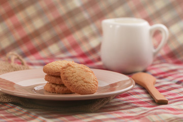 Round sweet cookies. Delicious dessert with high sugar and carbohydrate suitable for eating with milk and tea or coffee on color and white background with colorful placemat